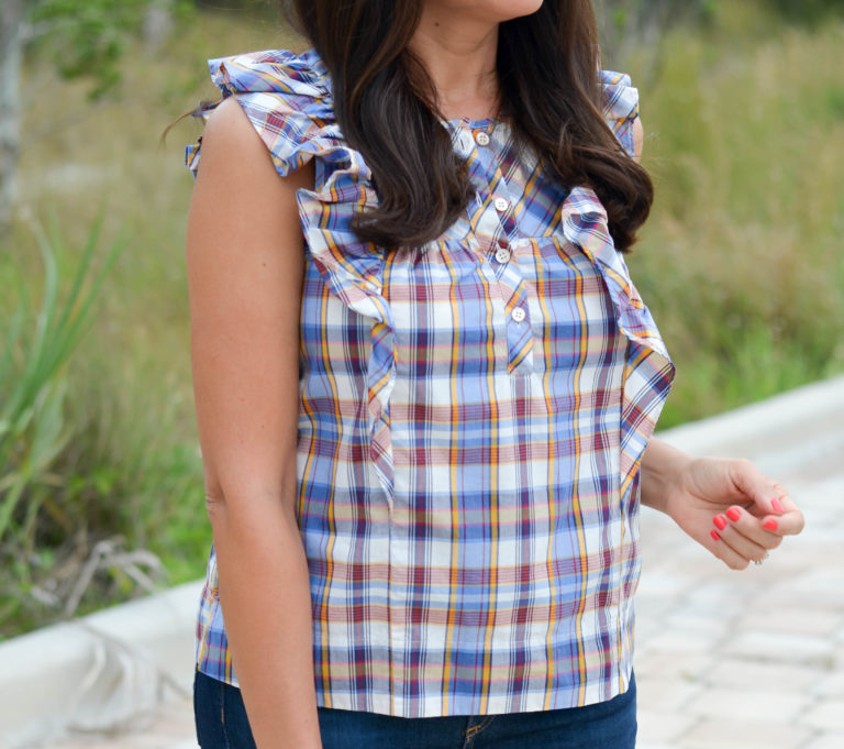 Lifestyle blogger Desiree of Beautifully Seaside wearing J.Crew vintage plaid ruffle top, Rag & Bone high waisted denim jeans , Gucci sunglasses, Tory Burch flip flops.