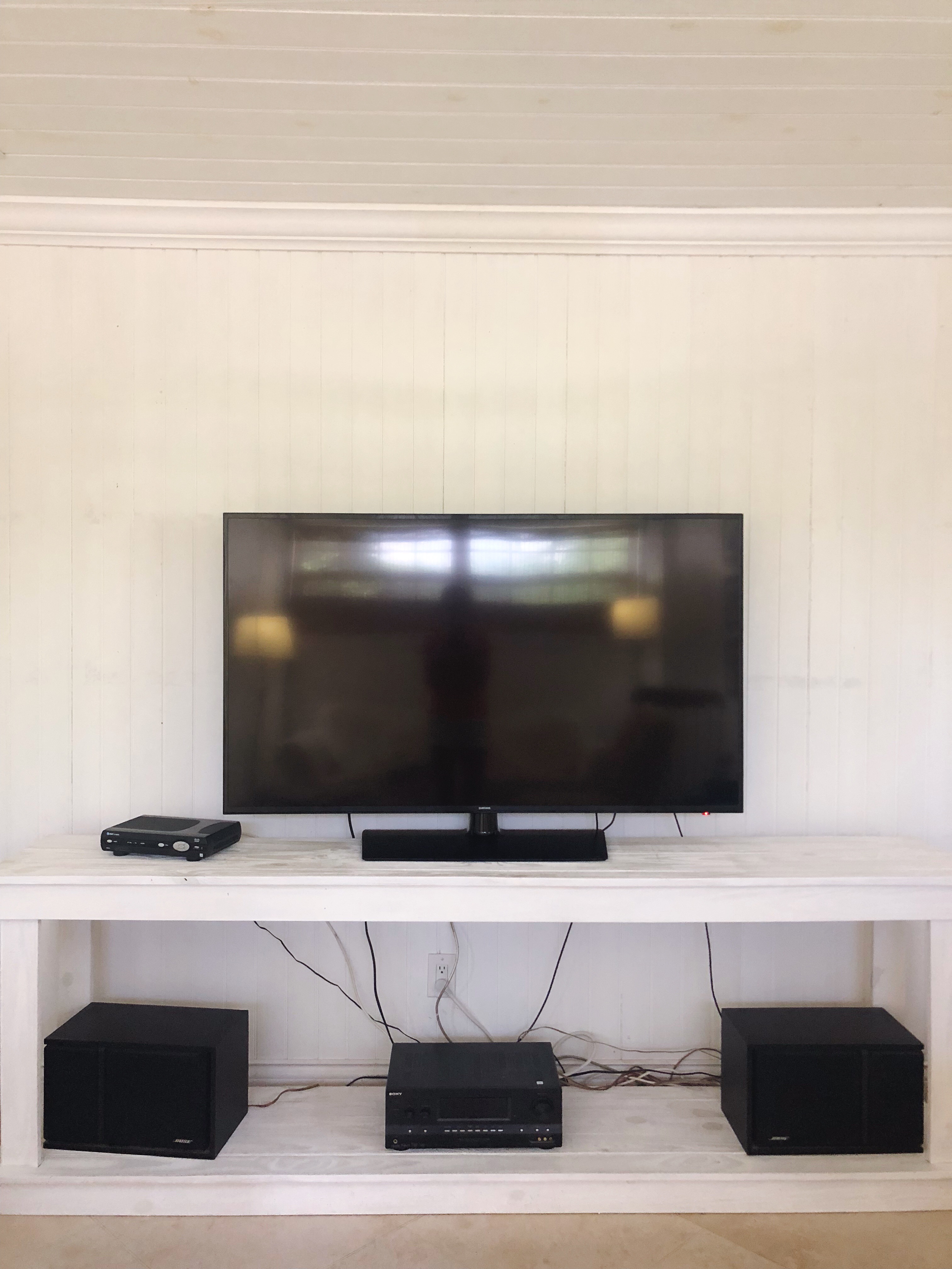 summer paint project that makes the TV stand out and the walls white