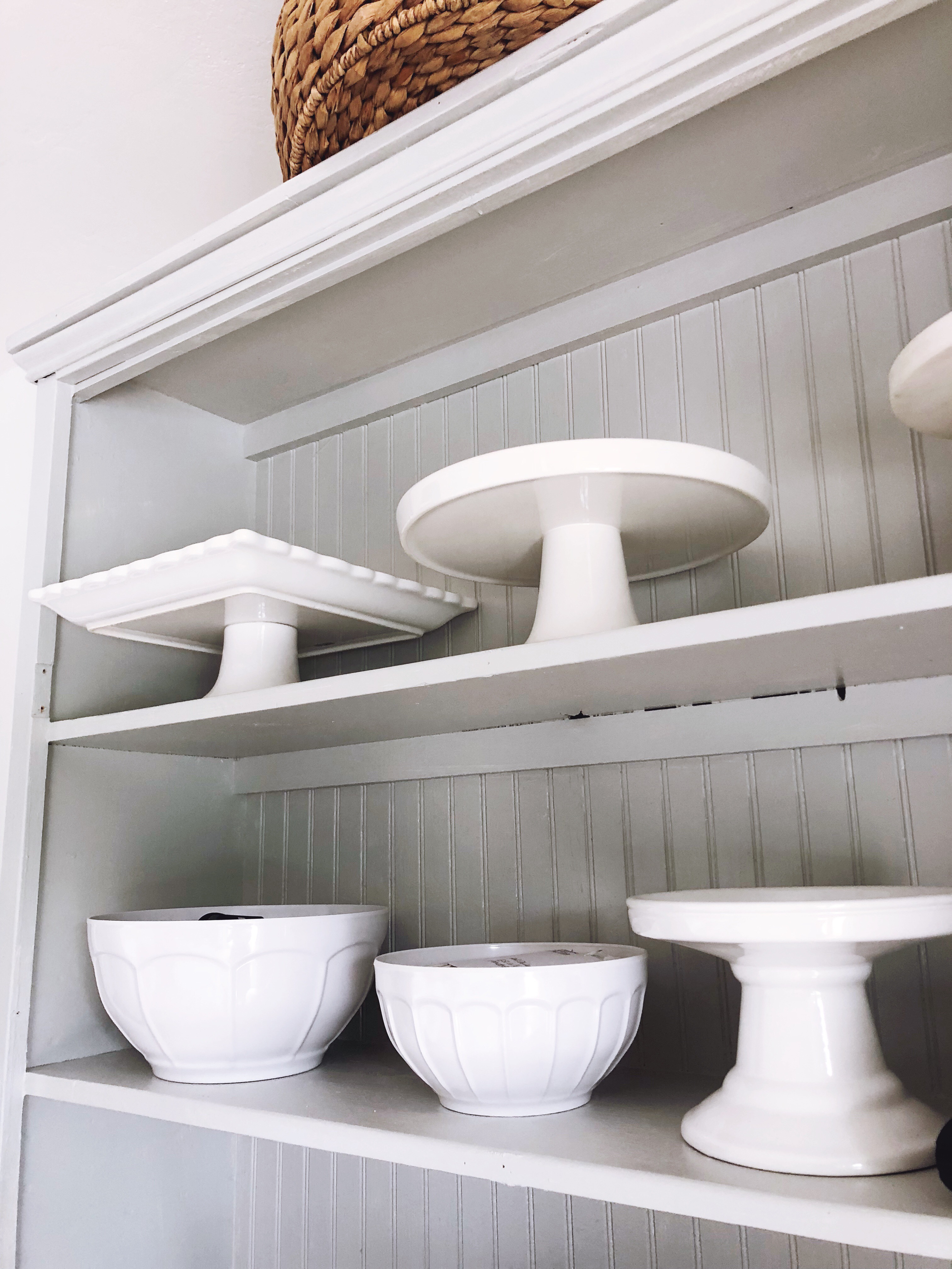 summer paint project of white shelves and white serving platters