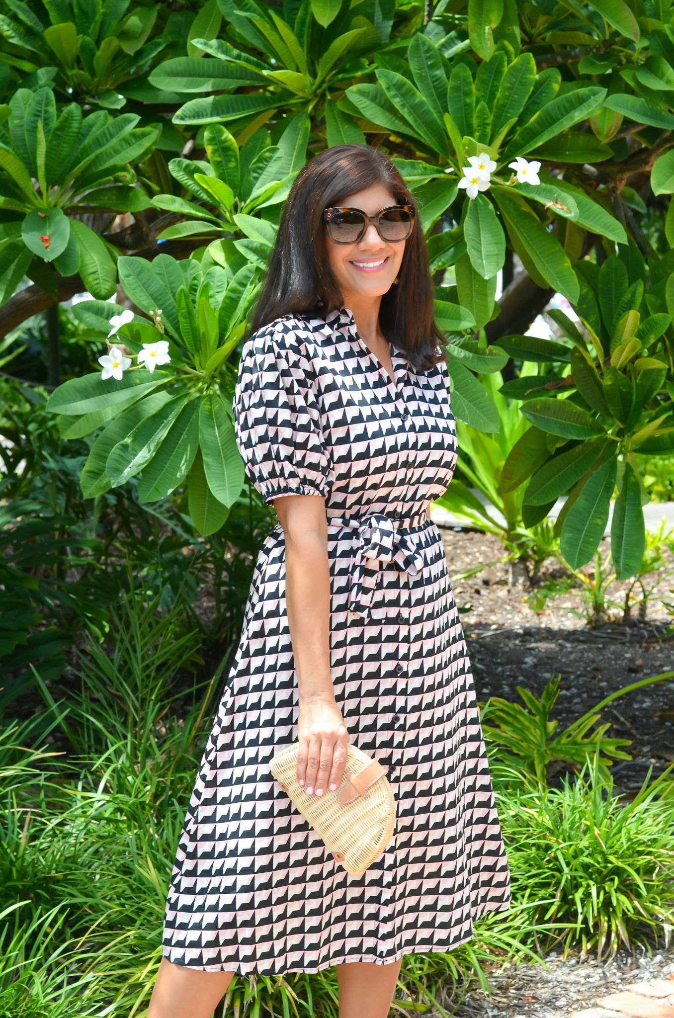 a woman in sunglasses and a wrap dress for work