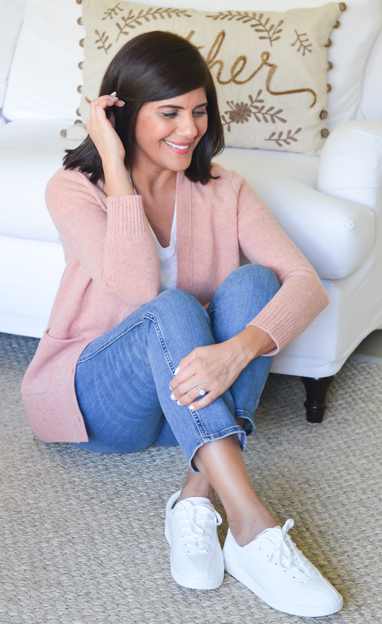 Desiree Leone of Beautifully Seaside wearing a casual fall outfit cardigan, white t-shirt, jeans, Tretorn Sneakers