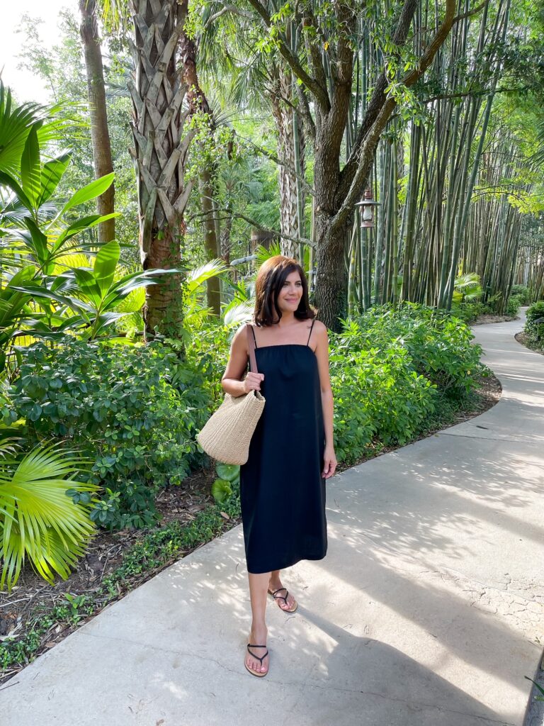 Desiree Leone of Beautifully Seaside wearing a black linen dress from Target.