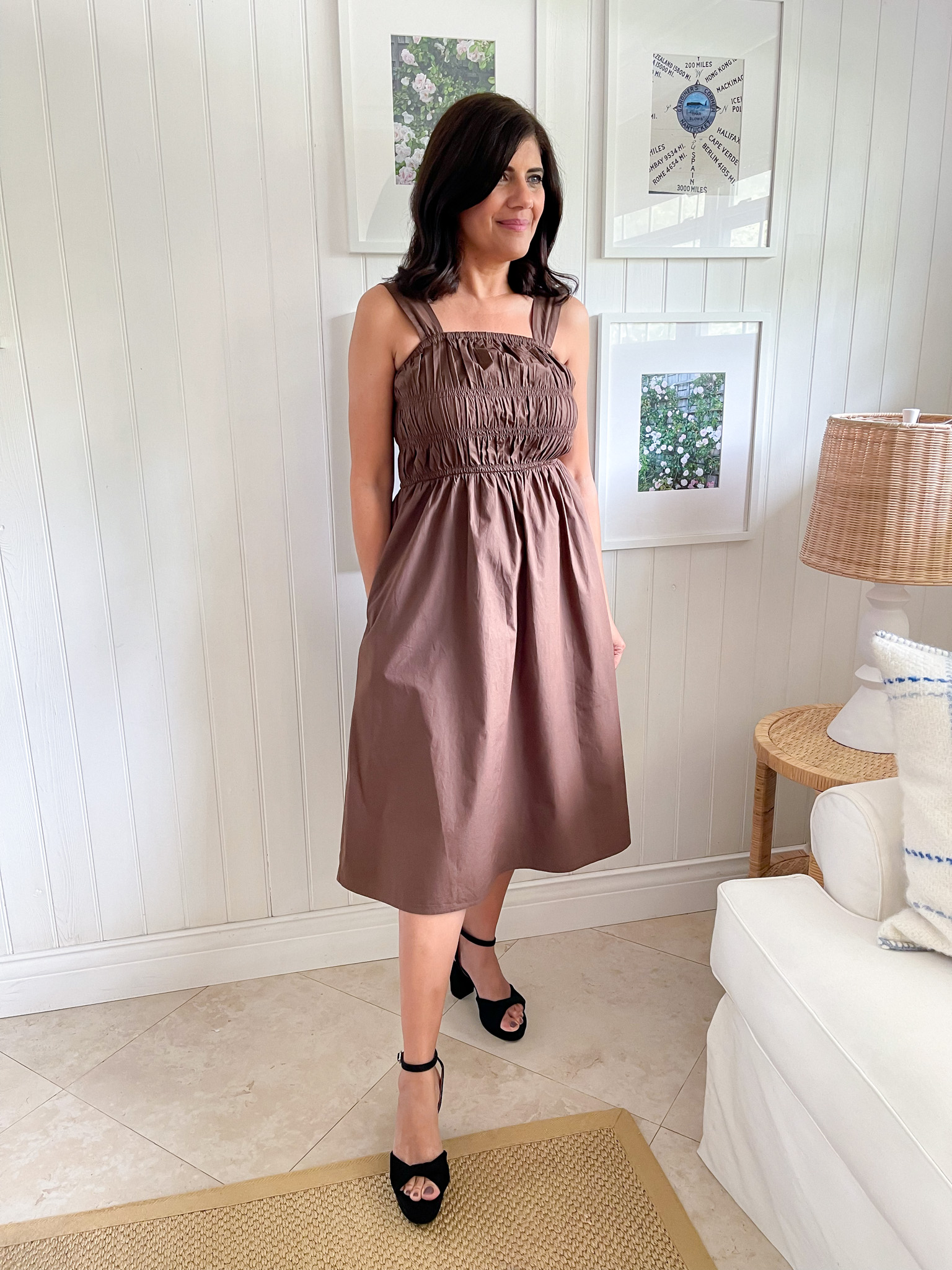 Desiree Leone of Beautifully Seaside is wearing a brown midi dress by Amazon The Drop.