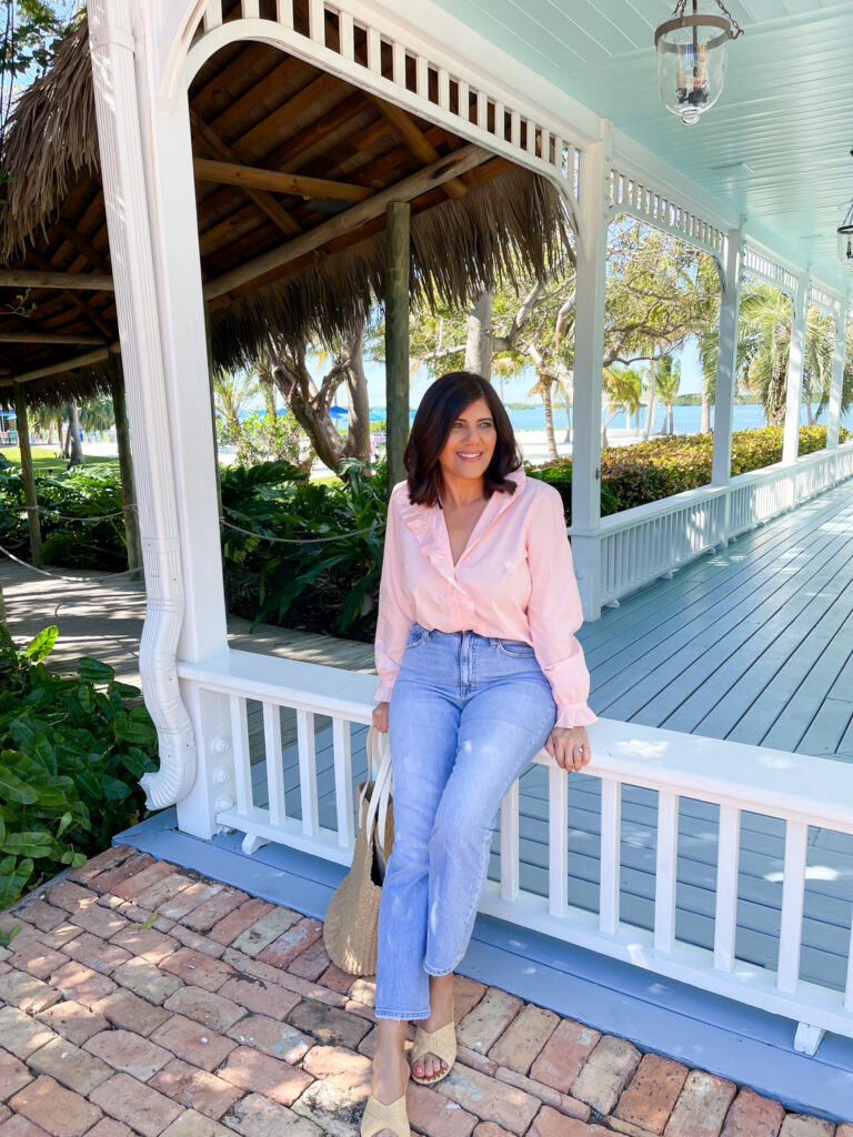 Desiree Leone of Beautifully Seaside is wearing the J.Crew cottage top. A frilly, button-up top that's perfect for wear with jeans.