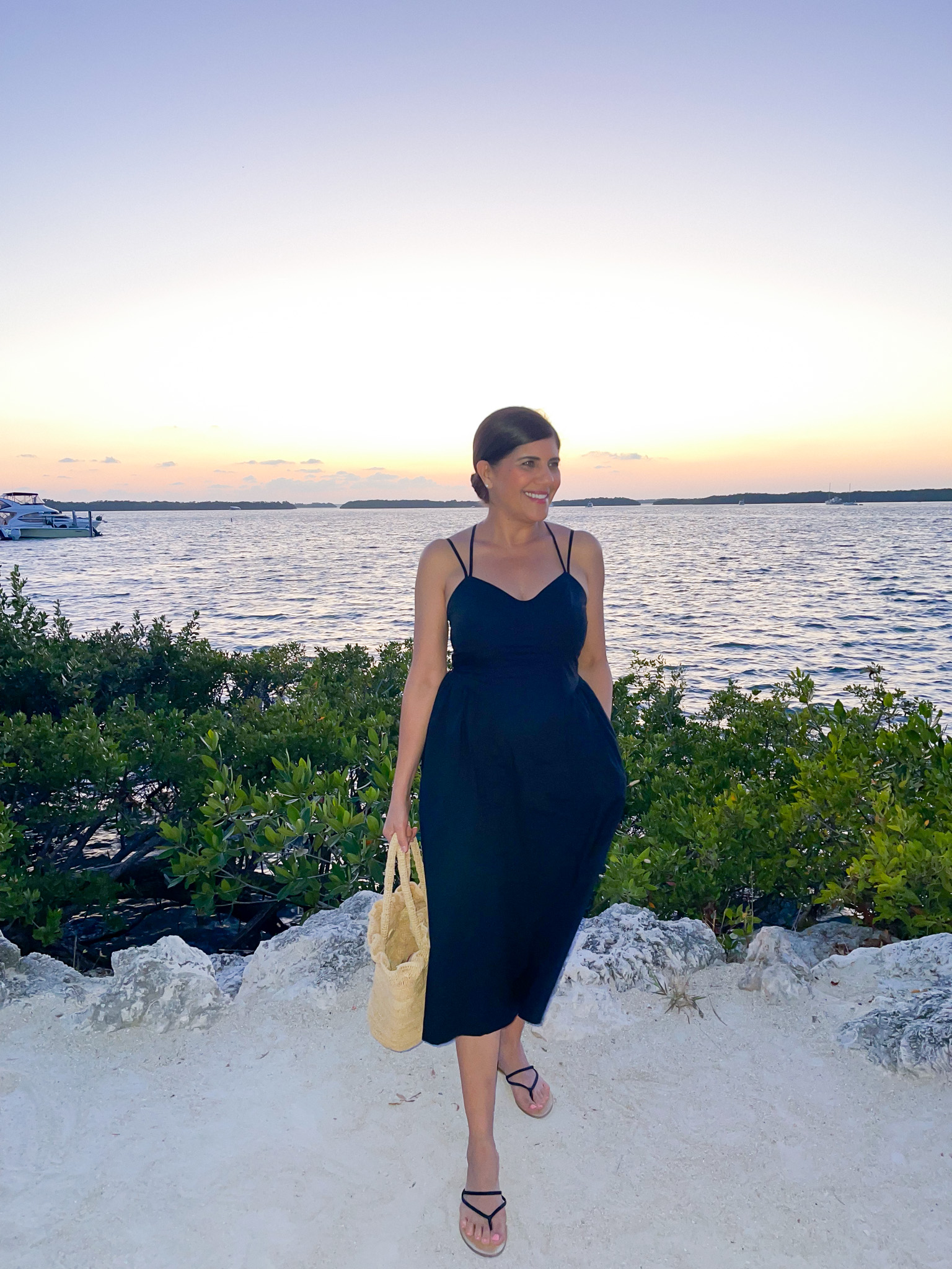 Desiree Leone of Beautifully Seaside wearing a black vacation dress by Target.