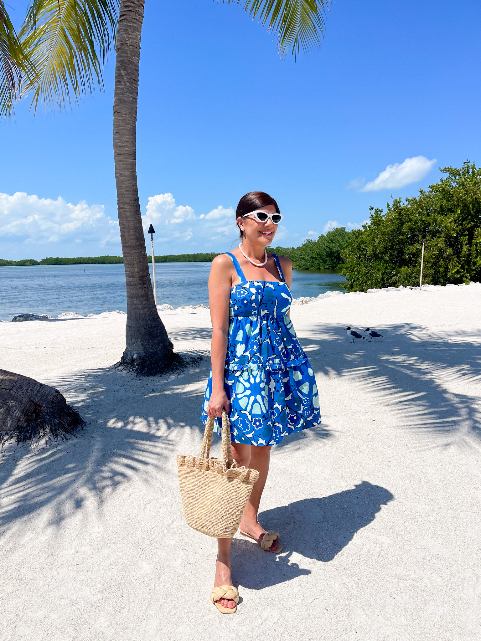 Desiree Leone of Beautifully Seaside shares stylish resortwear looks for under $50 that you can pack for your next vacation, including this Rhode floral mini dress at Target.